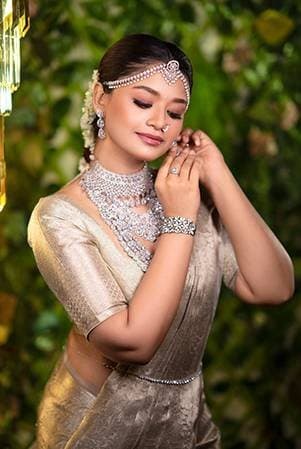 Look in a gold tissue saree with a diamond choker and fresh jasmine in the hair