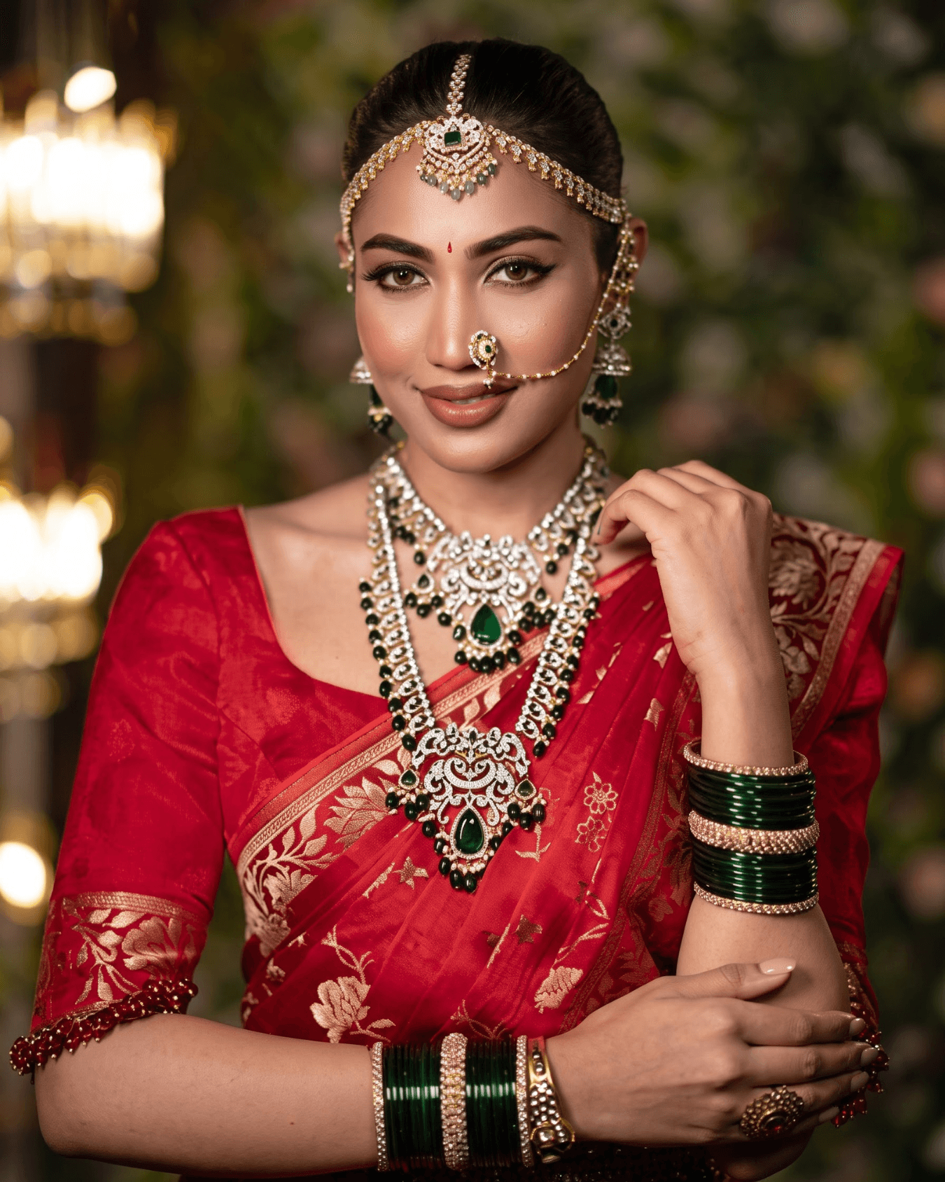 Bride in a red silk saree with temple jewellery and a gold matha patti
